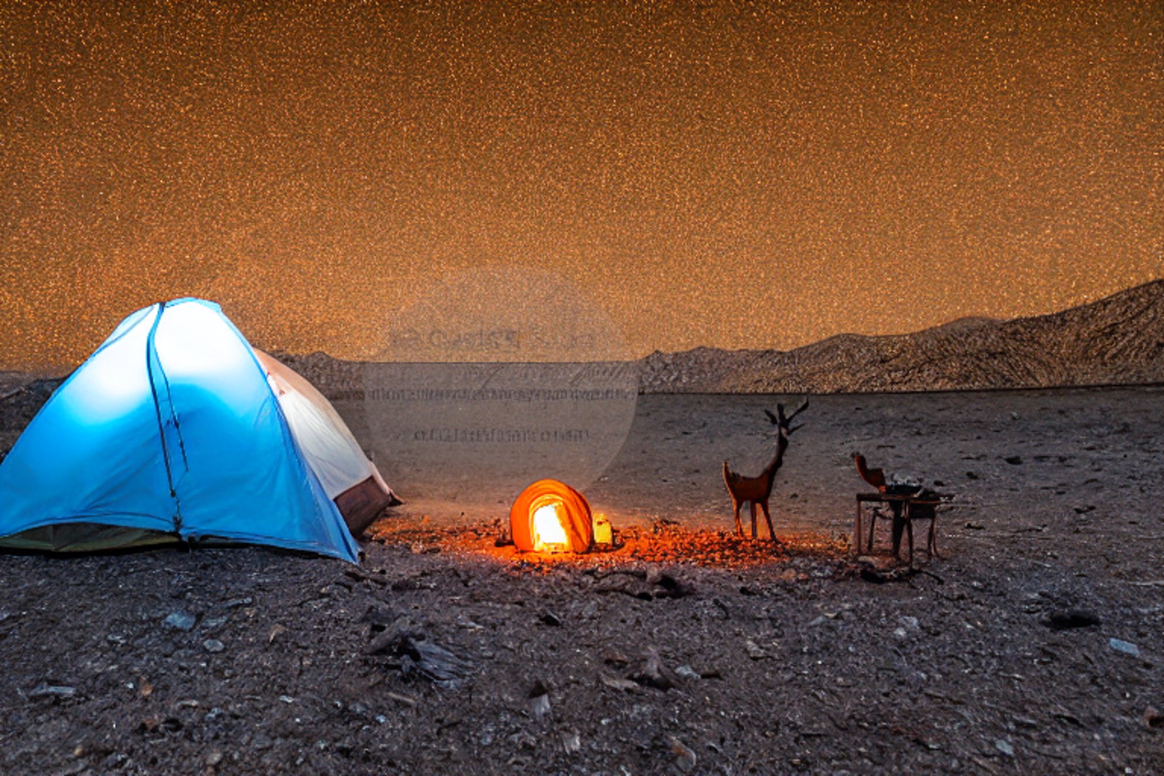 A white tent glows beside a warm campfire on the rocky ground of Death Valley. Snow falls softly as a wooden guitar and camping lantern rest nearby. In the distance, a lone deer watches under the dark night sky.
