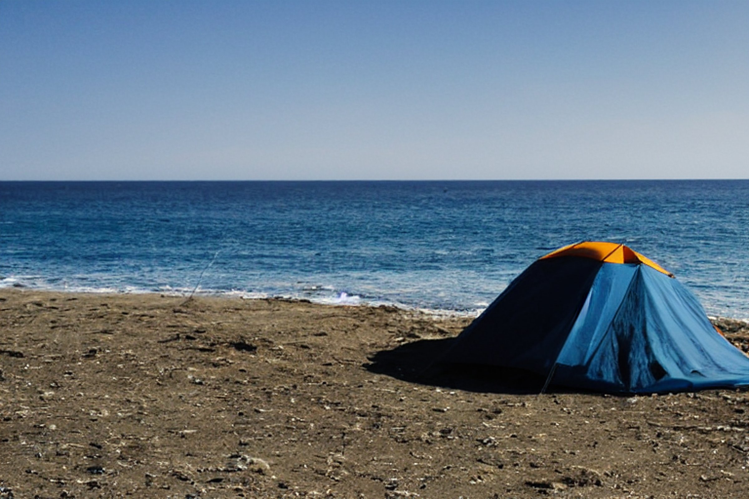Tent at campsite on a beach during sunset