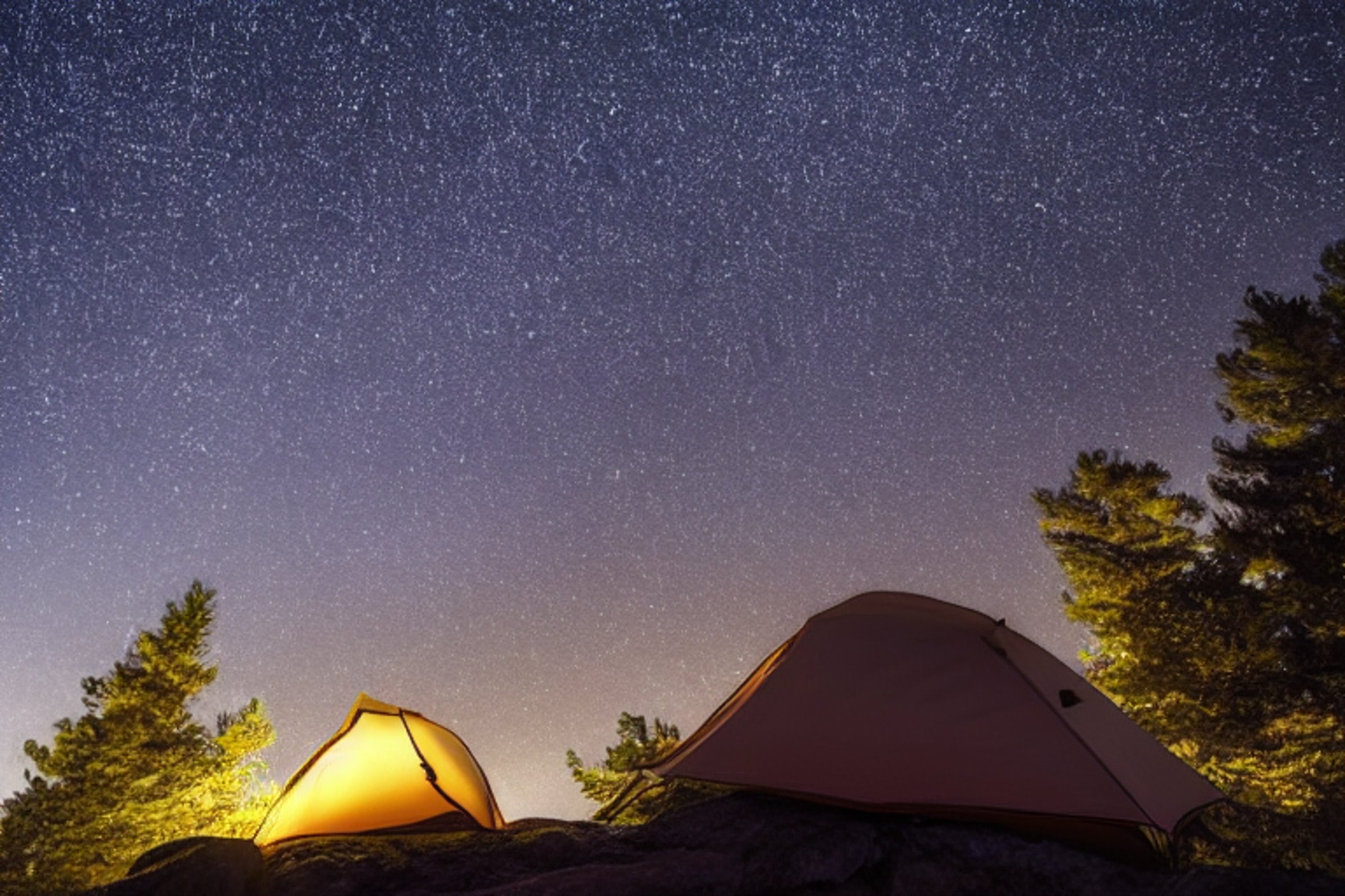 tent at campsite on the top of a mountain with a starry sky