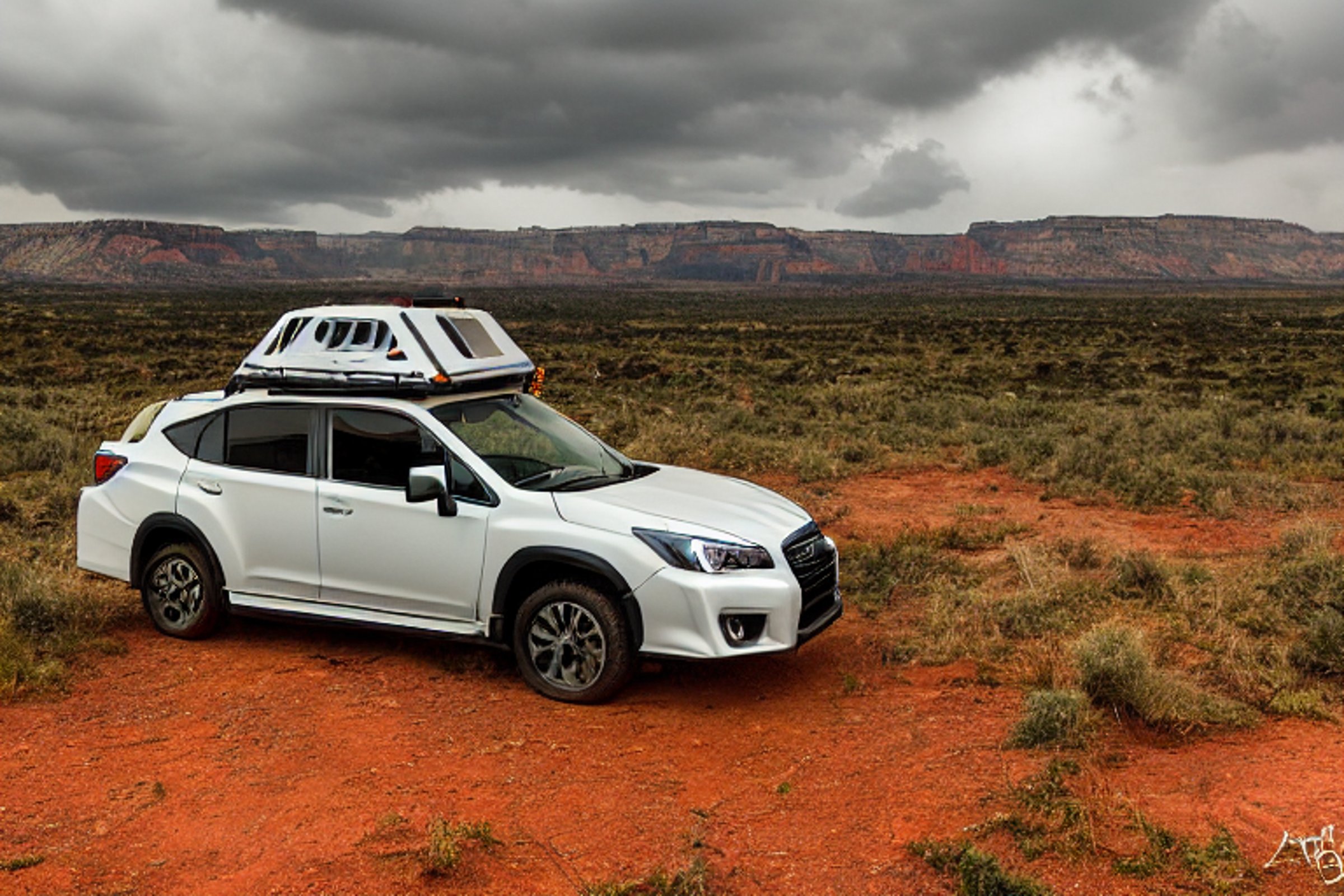 An orange Subaru with its rooftop tent open rests at a quiet campsite in Capitol Reef National Park. Tall grass, fallen leaves, and a dirt trail surround the picnic table. Stormy skies add a wild, cozy feeling to the nighttime scene.